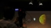 A video journalist points his camera at a screen with a rendering during an event organized by Italy's Space Agency, on the occasion of the insertion of the Trace Gas Orbiter into orbit around Mars, and the landing of the Schiaparelli module on the surface of the planet, in Rome, Wednesday, Oct. 19, 2016.