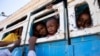 Refugees who fled the conflict in Ethiopia's Tigray region ride a bus going to the Village 8 temporary shelter, near the Sudan-Ethiopia border, in Hamdayet, eastern Sudan, Dec. 1, 2020. 