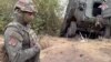 FILE - In this photo taken from video released by the Russian Defense Ministry on Sept. 13, 2024, a Russian soldier stands next to a damaged Ukrainian military vehicle in the Russian-Ukrainian border area in the Kursk region, Russia.