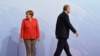 FILE - German Chancellor Angela Merkel and Turkey President Recep Tayyip Erdogan go their separate ways after a handshake greeting at the beginning of the G20 summit in Hamburg, Germany, July 7, 2017.