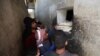 FILE - Syrians buy bread at a shop in the town of Binnish in the country's northwestern Idlib province on June 9, 2020.