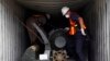 Panama forensic workers work in a container holding a green missile-shaped object seized from the North Korean flagged ship "Chong Chon Gang" at the Manzanillo Container Terminal in Colon City July 17, 2013. 