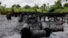 FILE- An abandoned illegal refinery is seen after it was raided by the Nigeria navy at the creeks of Bayelsa, Nigeria, May 18, 2013. At the time, the navy said it had destroyed 260 illegal refineries and burned 100,000 tons of contraband fuel to try to halt oil thefts bedeviling the economy of Africa's biggest petroleum producer.