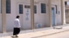 Jewish woman walks in the neighborhood of Hara Kbira Tunisia's southeastern island of Djerba. (L. Bryant/VOA)