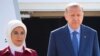 Turkish President Recep Tayyip Erdogan and his wife, Emine, arrive at the Tegel airport in Berlin, Germany, Sept. 27, 2018. 