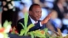 FILE - Kenya's President Uhuru Kenyatta reacts as he attends Mashujaa (Heroes) Day at the Nyayo National Stadium in Nairobi, Oct. 20, 2013. 
