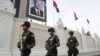 Cambodian government security forces walk in front of the Council of Ministers building as they patrol along a street ahead of the 21st ASEAN Summit and other related summits in Phnom Penh, November 13, 2012.
