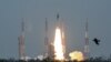 A man at New Delhi's Nehru Planetarium, takes pictures of a web cast of the lift off of Indian Space Research Organization (ISRO)'s Geosynchronous Satellite launch Vehicle (GSLV) MkIII carrying Chandrayaan-2 from Satish Dhawan Space center in Sriharikota