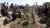 The victims of a deadly mosque attack, Aug. 3, 2018, in Gardez, the capital of Paktia province, eastern Afghanistan, were buried in a common grave Saturday under tight security.