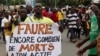 FILE - A man holds up a sign, which reads: "Faure still how many death by you," during an opposition protest calling for the immediate resignation of President Faure Gnassingbe in Lome, Togo, Sept. 6, 2017. 
