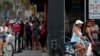 FILE - People stand in line at a restaurant by the beach after it was opened amid coronavirus disease (COVID-19) restrictions in Jacksonville, Florida, April 19, 2020.