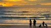Tourists stand on Bang Tao Beach in Phuket, southern Thailand, Oct. 22, 2021. 