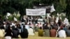 FILE - Nangarhar University students gather as some raise Taliban and Islamic State flags in Jalalabad, Afghanistan, Nov. 8, 2015. An Afghan official said the government is investigating links between universities and extremist groups.