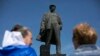 Pro-Russian activists stand in front of a monument of Soviet leader Vladimir Lenin during a rally in Donetsk, eastern Ukraine, April 27, 2014.
