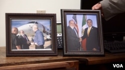 El alcalde de Nogales, Arizona, John Doyle exhibe una foto suya junto a su contraparte de Nogales, México. A la izquierda, una foto suya junto al secretario de Seguridad Nacional, John Kelly. (Foto: R. Taylor/VOA)