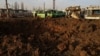 A crater is seen after a Russian missile strike at a compound of a public transport depot, amid Russia's attack on Ukraine, in Kharkiv, Ukraine Dec. 20, 2023.