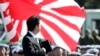 FILE - Japanese Prime Minister Shinzo Abe reviews members of Japan Self-Defense Forces (SDF) during the Self-Defense Forces Day at Asaka Base, north of Tokyo, Sunday, Oct. 27, 2013.