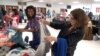 A high school cafeteria in Springfield, Virginia is the site of a large clothing swap, where over 300 attendees participated. 