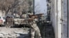 FILE - A member of Libyan National Army fires a weapon during clashes with Islamist militants in the militants' last stronghold in Benghazi, Libya, July 6, 2017.