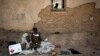 Displaced pygmies sit with their belongings outside a classroom, which serves as their shelter by night, Dec. 16, 2017 in Oicha. Attacks allegedly carried out by the Ugandan Muslim Group, ADF in Eastern Democratic Republic of the Congo (DRC), have displaced thousands of Pygmies.