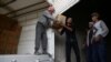People unload humanitarian supplies in the town of Nashabiyeh, eastern Ghouta in Damascus, Syria, Nov. 28, 2017. 