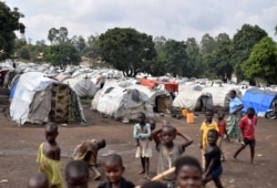 FILE - Congolese children are seen at a makeshift camp for internally displaced people in Bunia, Ituri province, eastern Democratic Republic of the Congo, June 25, 2019.