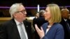 European Union foreign policy chief Federica Mogherini, right, speaks with European Commission President Jean-Claude Juncker during a round table meeting of the EU-Sahel at EU headquarters in Brussels, Feb. 23, 2018. 