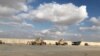 FILE - Military vehicles of U.S. soldiers are seen at the Al-Asad Air Base in Anbar province, Iraq, Jan. 13, 2020. "Multiple ballistic missiles and rockets" were fired by Iran-backed militants at Al-Asad Air Base in western Iraq on Jan. 20, 2024, the U.S. military said.