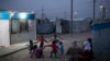FILE - Syrian kids play outside their tents in the Kawergosk refugee camp in northern Iraq, April 8, 2017. 