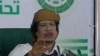 This video image taken from Libyan state television broadcast Wednesday March 2, 2011 shows Libyan leader Moammar Gadhafi addressing supporters and foreign media on Wednesday in a conference hall in the capital Tripoli, Libya