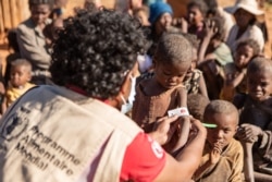 Children get MUAC measurements taken by WFP staff in Ambovombe, one of the districts with a very high number of malnourished children, June 11, 2021. (Credit: WFP/Tsiory Andriantsoarana)