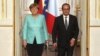 France's President Francois Hollande, right, and German chancellor Angela Merkel arrive to give a press conference, at the Elysee Palace, in Paris, July 6, 2015. 