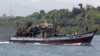 Filipino fishermen wave from a fishing boat bound to fish near Scarborough Shoal in Masinloc, Zambales May 10, 2012. 