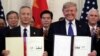 China's Vice Premier Liu He gestures to the media between U.S. Trade Representative Robert Lighthizer (L) and Treasury Secretary Steve Mnuchin before the two countries' trade negotiations in Washington, U.S., October 10, 2019.
