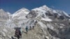 FILE - Climbers pass through a glacier at the Mount Everest base camp, Nepal, Feb. 22, 2016.