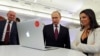 FILE - Russian President Vladimir Putin and Editor-in-chief of RT (Russia Today) 24-hour English-language TV news channel, Margarita Simonyan, attend an exhibition marking RT's 10th anniversary in Moscow, Russia.