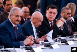 Libya Chief of Staff, Marshall Khalifa Haftar, President of the Libyan House of Representatives in Tobruk Aguila Saleh Issa, Chairman of the Presidential Council of Libya, Fayez al-Sarraj and President of Libya High Council Khaled Mechri attend an International conference at the Elysee Palace in Paris, May 29, 2018.