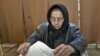 An elderly woman casts a ballot in Sintesti, Romania, Sunday, December 9, 2012. 
