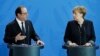 German Chancellor Angela Merkel, right, and the President of France, Francois Hollande, left, address the media during a joint statement as part of a meeting at the chancellery in Berlin, Germany, Jan. 27, 2017.