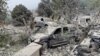 Lebanese army soldiers stand near destroyed vehicles at a site damaged by an Israeli airstrike in the Christian-majority region of Aitou in north Lebanon, the Lebanese health ministry said, Oct. 14, 2024. 