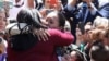 Gabriela Esparza was able to hug her mother and sister on April 30 during a symbolic event when an emergency door at the U.S.-Mexico border in California was opened for a brief time. 