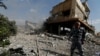 FILE - A Syrian firefighter is seen inside the destroyed Scientific Research Center in Damascus, Syria, April 14, 2018.