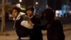 FILE - Tunisian security forces detain a protester on the outskirts of Tunis, Jan. 10, 2018.