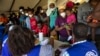 Haitians who were deported from US border with Mexico are attended by members of the IOM UN Migration organization before they get tested for COVID-19 at Toussaint Louverture International Airport in Port-au-Prince, Haiti, Sept. 20, 2021.