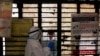 A medical worker gets ready to collect a sample from a man at a school turned into a center to conduct tests for the coronavirus disease (COVID-19), amidst its spread in New Delhi, India, June 22, 2020.