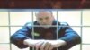 FILE - Russian opposition leader Alexei Navalny is seen on a screen via a video link from the IK-2 corrective penal colony in Pokrov during a court hearing to consider an appeal against his prison sentence in Moscow, Russia May 24, 2022. 