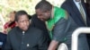 Then-acting President Edgar Lungu (l) talks to foreign affairs minister Harry Kalaba during a military exhibition march, Oct. 24, 2014 to mark Zambia's 50th Independence celebration. 