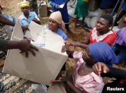 FILE - Victims of Cyclone Idai receive food aid at Siverstream Estates in Chipinge, Zimbabwe, March 24 ,2019.