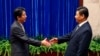 Japan's Prime Minister Shinzo Abe shakes hands with China's President Xi Jinping (R) during their meeting at the Great Hall of the People, on the sidelines of the Asia Pacific Economic Cooperation (APEC) meetings, in Beijing, Nov. 10, 2014. 