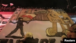 Protesters hold an anti-refugee banner during a rally, organized by far-right, nationalist groups, to mark the 99th anniversary of Polish independence in Warsaw, Nov. 11, 2017.